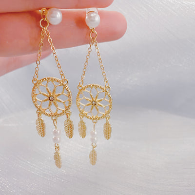 Feather Dreamcatcher Dangle Earrings in hand